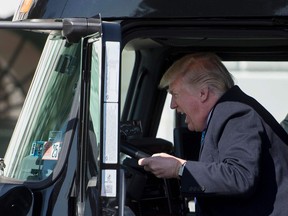 Photo of the day: U.S. President Donald Trump sits in the drivers seat of a semi-truck as he welcomes truckers and CEOs to the White House in Washington, DC, March 23, 2017 ... to discuss healthcare.