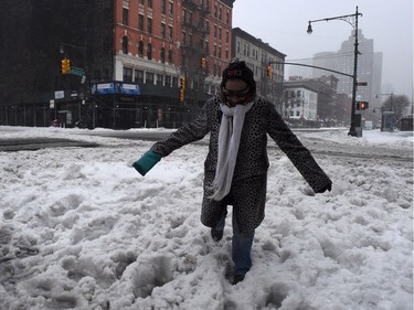 As Winter Storm Stella began, on Tuesday, March 14, 2017, a woman struggles to cross a snow covered street in New York City. Blizzard warnings for parts of Connecticut, Massachusetts and upstate New York were lifted for New York City, the US financial capital home to 8.4 million residents, where snow turned to sleet, hail and rain.
