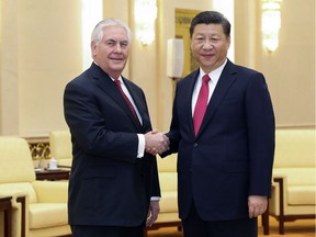U.S. State of Secretary Rex Tillerson, left, shakes hands with China's President Xi Jinping at the Great Hall of the People in Beijing, China Sunday, March 19, 2017.