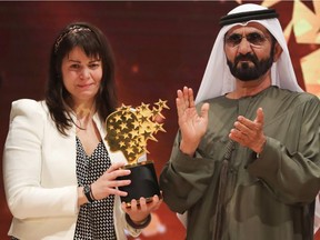 Canadian teacher Maggie MacDonnell receives the Global Teacher Prize from Sheikh Mohammed bin Rashid al-Maktoum, vice-president and Prime Minister of the UAE and Ruler of Dubai, during a ceremony in Dubai on March 19, 2017.