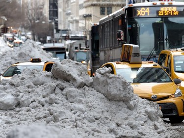 Taxis and buses in New York City navigate around the snow banks left after Winter Storm Stella dumped snow and sleet across the northeastern U.S., cancelling thousands of flights, closing schools and shutting stores, but New York and Washington escaped the worst of the weather. Timothy A. Clary / AFP/Getty