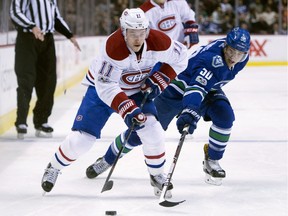 Canadiens' Brendan Gallagher (11) battles Canucks' Brendan Gaunce for control of the puck Tuesday night in Vancouver.