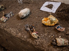 Dineo Seshee Bopape's Darling Foundry installation AND- IN. THE LIGHT OF THIS.___  includes objects placed atop a mud-brick "altar" that are used in ceremonies to purify the body in many African cultures. The pile of dry soil is a reminder of how the body is made of earth and will return to the earth. In a dish is a bronze cast of the artist's uterus.