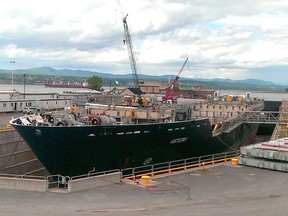 Local Input~ A commercial ship is being converted at Quebec’s Chantier Davie shipyards into an interim supply vessel for the Canadian navy. This photo, taken today, shows the hollowed out portion of the ship’s hull in order to accept the new fuel tanks as well as a superstructure. Photo courtesy of Federal Fleet Services  // 0223 na ship