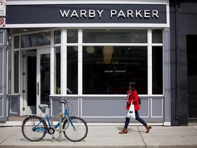 A woman walk by U.S. based eyewear boutique Warby Parker&#039;s flagship Toronto store on Queen St., in Toronto, on Sunday, April 9, 2017. THE CANADIAN PRESS/Cole Burston