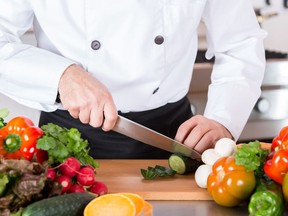 Chef cutting fresh and delicious vegetables for cooking