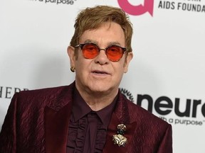 FILE - In this March 25, 2017 file photo, Elton John arrives at Elton John&#039;s 70th Birthday and 50-Year Songwriting Partnership with Bernie Taupin celebration in Los Angeles. Elton John has cancelled more than a month of upcoming shows after contracting an ‚Äúunusual‚Äù bacterial infection during a South America tour that left him in intensive care for two nights. The 70-year-old performer is expected to make a full recovery and hopes to return to a stage in Twickenham, England on June 3. (Photo