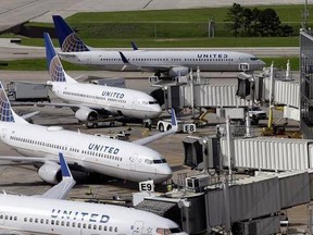 FILE - In this July 8, 2015, file photo, United Airlines planes are parked at their gates as another plane, top, taxis past them at George Bush Intercontinental Airport in Houston. United Airlines says it will raise the limit to $10,000 on payments to customers who give up seats on oversold flights and will increase training for employees as it deals with fallout from the video of a passenger being violently dragged from his seat. (AP Photo/David J. Phillip, File)