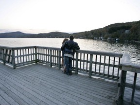 A couple stands on a boardwalk next to the Massawippi Lake in North Hatley, Wednesday, Sept. 27, 2006.