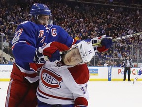 Rangers' Ryan McDonagh hammers Canadiens pest Brendan Gallagher Sunday night at Madison Square Garden.
