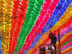 Photo of the day: A South Korean worker attaches a name card with a wish from Buddhist followers to a lotus lantern at Jogye Temple in Seoul on April 12. The temple is decorated with thousands of colourful lanterns in celebration of Buddha's birthday on May 3.