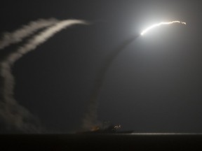 In this file image provided by the U.S. Navy on Tuesday, Sept. 23, 2014, the guided-missile cruiser USS Philippine Sea (CG 58) launches a Tomahawk cruise missile. The U.S. fired a barrage of cruise missiles into Syria Thursday, April 6, 2017, in retaliation for this week's chemical weapons attack on civilians, U.S. officials said.