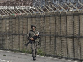 A South Korean army soldier walks along the military wire fences on Unification Bridge, which leads to the demilitarized zone, near the border village of Panmunjom in Paju, South Korea.