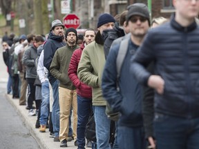 French expats wait in line to vote in Montreal on Saturday. Emmanuel Macron and Marine Le Pen will face each other in a runoff on May 7.