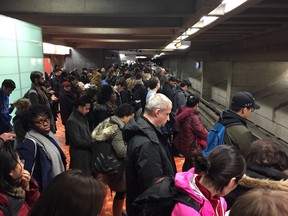 Passengers wait at the Lionel-Groulx métro stop as the Orange Line experiences delays.