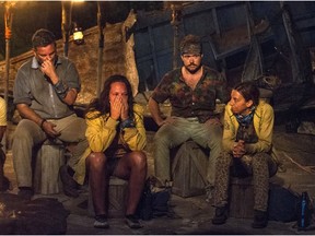 In this image released by CBS, contestants, from left, Jeff Varner, Sarah Lacina, Zeke Smith and Debbie Wanner appear at the Tribal Council portion of the competition series Survivor: Game Changers.
