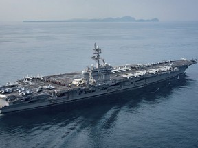 The aircraft carrier USS Carl Vinson transits the Sunda Strait between the Indonesian islands of Java and Sumatra.