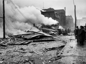 April 25, 1944: Firefighters work at the scene where a 25-ton bomber plane crashed in Griffintown, killing 15 people.