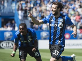 Impact midfielder Marco Donadel celebrates his goal against the Vancouver Whitecaps as teammate Chris Duvall cheers on during first half MLS action on Saturday, April 29, 2017 in Montreal.