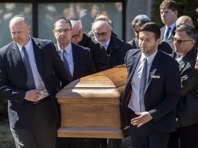 The coffin with the remains of Dr. Mark Wainberg is carried from the synagogue following his funeral in Montreal, Friday, April 14, 2017.