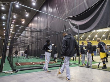 Members of the Pittsburgh Pirates take batting practice in a batting cage behind the outfield wall at Olympic Stadium, Saturday, April 1, 2017 in Montreal.