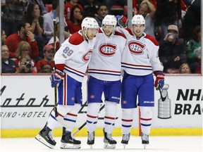 Canadiens' Alex Galchenyuk, centre, celebrates his goal against the Detroit Red Wings with Nikita Nesterov (89) and Artturi Lehkonen (62) in overtime of an NHL hockey game Saturday, April 8, 2017, in Detroit.