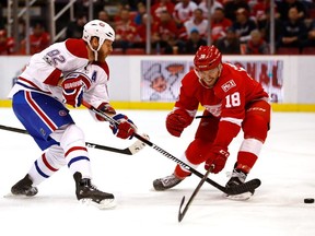 Canadiens' Artturi Lehkonen takes a first period shot past the stick of Robbie Russo of the Detroit Red Wings at Joe Louis Arena on Saturday, April 8, 2017 in Detroit.