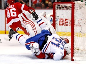 Canadiens' Alex Galchenyuk crashes into Petr Mrazek of the Detroit Red Wings during the first period at Joe Louis Arena on April 8, 2017 in Detroit.