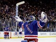 Henrik Lundqvist of the New York Rangers celebrates teammate Derek Stepan's empty net goal against the Canadiens during the third period in Game Six of the Eastern Conference First Round during the 2017 NHL Stanley Cup Playoffs at Madison Square Garden on Saturday, April 22, 2017 in New York City.