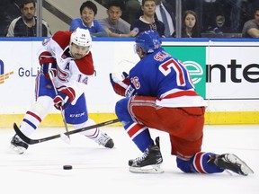 Canadiens' Tomas Plekanec takes a first period shot past Rangers' Brady Skjei Sunday night at Madison Square Garden in New York.