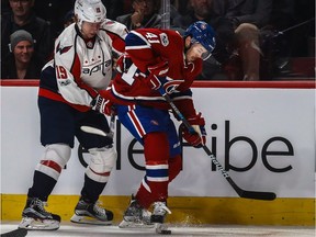 Washington Capitals' Nicklas Backstrom and Montreal Canadiens left-wing Paul Byron battle for the puck along the boards during 1st period NHL action at the Bell Centre in Montreal, on Monday, January 9, 2017.