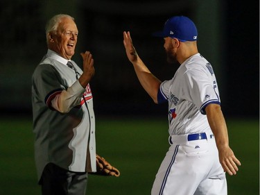 Former Montreal Expos Claude Raymond, left, is greeted by Blue Jays catcher Russell Martin during a pregame ceremony prior to the start of the Pittsburgh Pirates - Toronto Blue Jays preseason game at Olympic Stadium in Montreal, on Saturday, April 1, 2017.