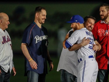 Toronto Blue Jays and native Montrealer Russell Martin greets, left to right, Raymond Daviault, Eric Cyr, Steve Green, hugging Martin, and Philippe Aumont prior to the start of the Pittsburgh Pirates - Toronto Blue Jays preseason game at Olympic Stadium in Montreal, on Saturday, April 1, 2017.