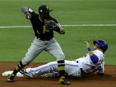 Toronto Blue Jays left fielder Steve Pierce is out at 2nd base as Pittsburgh Pirates 2nd baseman Josh Harrison can't turn the double play on Blue Jays right fielder Melvin Upton Jr.'s single during the preseason game at Olympic Stadium in Montreal, on Saturday, April 1, 2017.