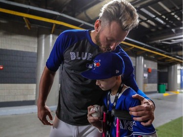 Toronto third baseman Josh Donaldson kisses 8-year-old Tea Kinsella after autographing a baseball for her prior to the start of the Pittsburgh Pirates - Toronto Blue Jays preseason game at Olympic Stadium in Montreal, on Saturday, April 1, 2017.