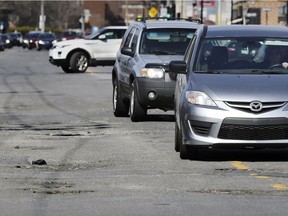 Cars drive on the wrong side of the road to avoid potholes on Somerled Ave. between Walkley and Montclair Aves. in N.D.G. on April 10.