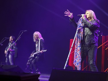 Def Leppard singer Joe Elliott performs with his bandmates Vivian Campbell, left, and bass player Rick Savage during concert in Montreal Monday April 10, 2017.