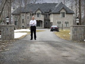 Maurice Poitras outside his Île- Bizard home that a Quebec Superior Court judge has ruled must be torn down. He is appealing the decision.