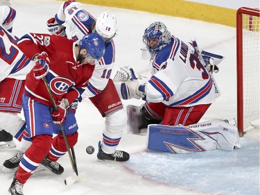 Canadiens Alex Galchenyuk battles for loose puck with Rangers Marc Staal in front of goalie Henrik Lundqvist Wednesday night at the Bell Centre.