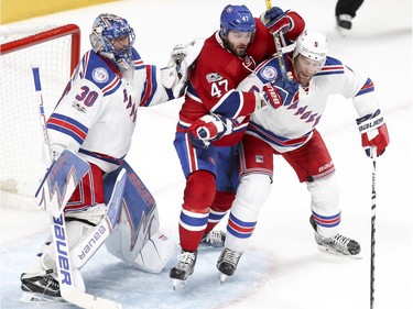 Montreal Canadiens Alexander Radulov fights for position between New York Rangers goalie Henrik Lundqvist and Dan Girardi during 1st period of game 1 of the first round of the NHL playoffs in Montreal Wednesday April 12, 2017.