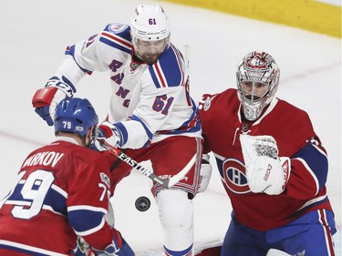 Montreal Canadiens Andrei Markov and Carey Price and New York Rangers Rick Nash look at loose puck during 3rd period of game 1 of the first round of the NHL playoffs in Montreal Wednesday April 12, 2017.