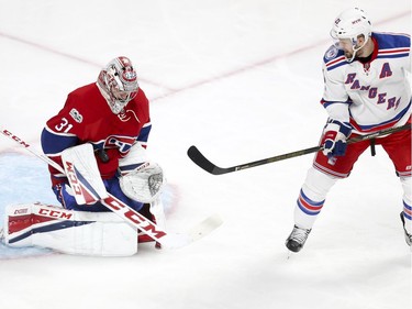 Montreal Canadiens Carey Price makes a save in front of New York Rangers Derek Stepan during 2nd period of game 1 of the first round of the NHL playoffs in Montreal Wednesday April 12, 2017.