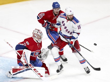 Montreal Canadiens Carey Price and Brandon Davidson watch puck with New York Rangers Tanner Glass during 2nd period of game 1 of the first round of the NHL playoffs in Montreal Wednesday April 12, 2017.