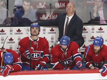 Montreal Canadiens coach Claude Julien looks up at the clock behind players, from left, Brendan Gallagher,Tomas Plekanec, Paul Byron and Steve Ott during 3rd period of game 1 of the first round of the NHL playoffs against the New York Rangers in Montreal Wednesday April 12, 2017.