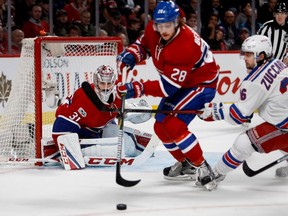 Montreal Canadiens goalie Carey Price keeps his eye on the puck as Montreal Canadiens defenceman Nathan Beaulieu and New York Rangers right-wing Mats Zuccarello battle for the loose puck during first round NHL playoff action at the Bell Centre in Montreal on Wednesday April 12, 2017.