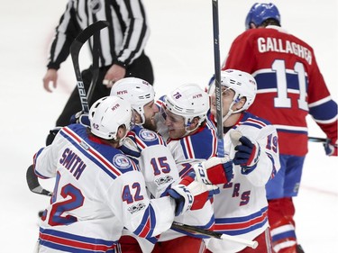 New York Rangers, from left, Brendan Smith, Tanner Glass, Brady Skjei and Jesper Fast celebrate Glass's game-winning goal during 1st period of game 1 of the first round of the NHL playoffs in Montreal Wednesday April 12, 2017.