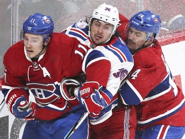 New York Rangers Mats Zuccarello is sandwiched between Montreal Canadiens Brendan Gallagher, left, and Tomas Plekanec during 3rd period of game 1 of the first round of the NHL playoffs in Montreal Wednesday April 12, 2017.