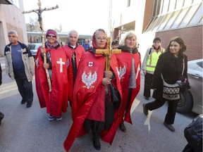 Congregants from the Matko Bosco Czestochowa Polish church take part in the Marche du Pardon Good Friday procession as it makes its way down Berri St. on the way to Mount Royal in Montreal Friday April 14, 2017.
