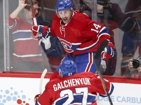 Canadiens' Tomas Plekanec jumps off the glass to celebrate his goal with Alex Galchenyuk against the New York Rangers to tie the game and send it to overtime during third period of a National Hockey League playoff series  in Montreal on Friday, April 14, 2017.