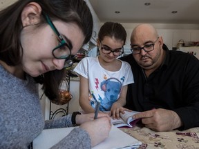 Rey Lopez suffered from kidney failure and started dialysis six months ago. Lopez and his kids, Elisa, left, 12, and Adriana, 9, do homework in Laval, on Tuesday, April 18, 2017.